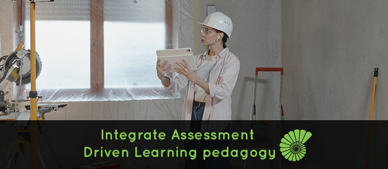 woman on construction site doing an assessment on her iPad text reads Integrate Assessment Driven Learning pedagogy with the Ammonite logo on the right hand side of the text