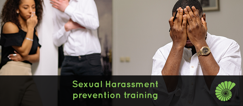 People working in office, man and woman standing on the left of another man who is distressed with his hands on his face, text says Sexual Harassment prevention training overlaying image, Ammonite logo on right hand corner